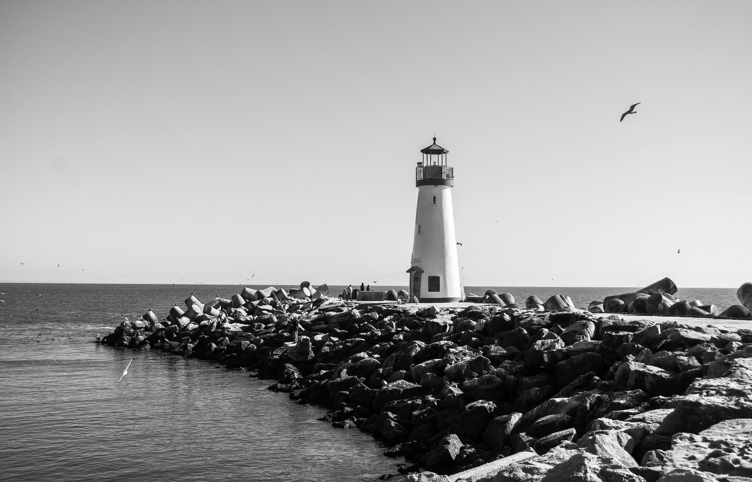 Lighthouse on rocky shore in Dana Point symbolizing guidance and stability at Ocean Hills Recovery dual diagnosis treatment center for mental health and addiction recovery.